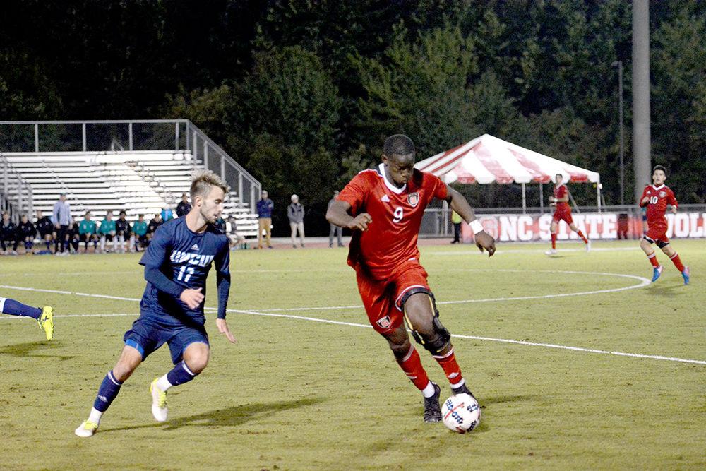 Ade Taiwo, a Wolfpack senior forwards, keeps the ball from Huntley Munn, a Seahawk junior defender, on Tuesday in Dail Soccer Stadium. Taiwo scored the winning goal of the game with under five minutes to go, bringing NC State a 2-1 win against UNC Wilmington.