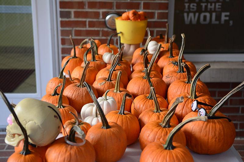 Pumpkins sit outside Clark Dining Hall for students to take as part of the Howl-O-Ween event held on Monday. Multiple sizes of pumpkins were offered and students could decorate the pumpkins with glitter, paint, pompoms and markers or keep them bare.