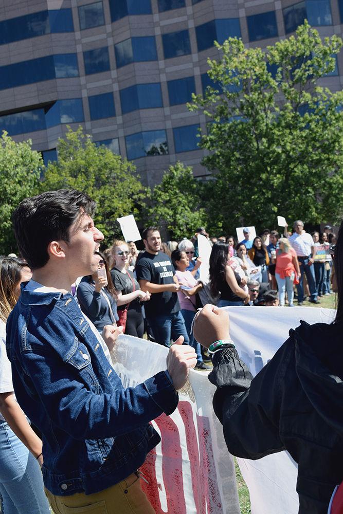Jorge Ramos, a Wake Tech student, leads a chant at the DACA march to defend the program on Sunday. Ramos is a part of the organization El Pueblo, which promotes youth leadership, and works to promote equality among the Latinx community. The DACA rally ended in Halifax Mall, where speakers, including Congressman Price, condemned Trump's decision to rescind the program.