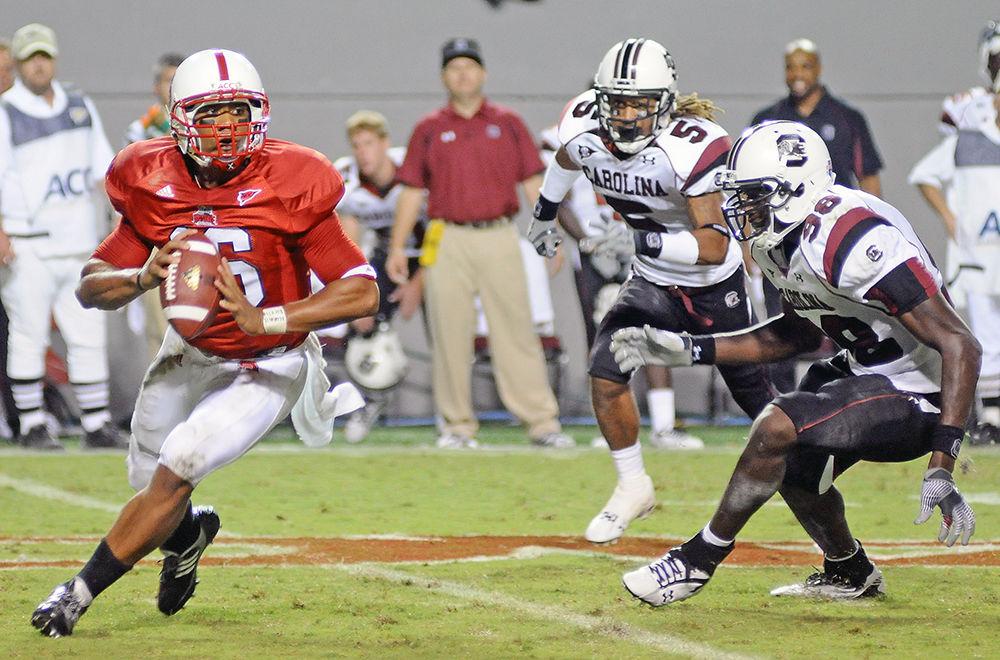 During the fourth quarter in Carter-Finely, redshirt sophomore quarterback Russell Wilson tries to dodge University of South Carolina's defense in the first home game of the season on Sept. 3, 2009. Wilson had 74 rushing yards in the 7-3 loss to USC.