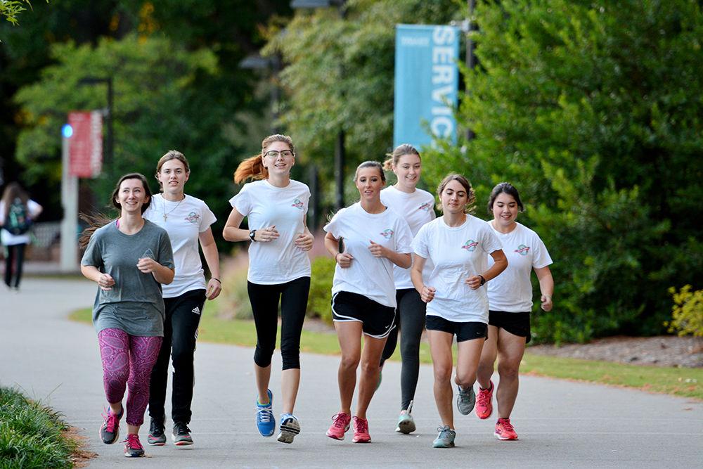 Members of We Run the World starting their run on a path outside of Talley Student Union on Oct. 19. The organization meets twice a week with a goal of promoting healthy lifestyles in women.&#160;