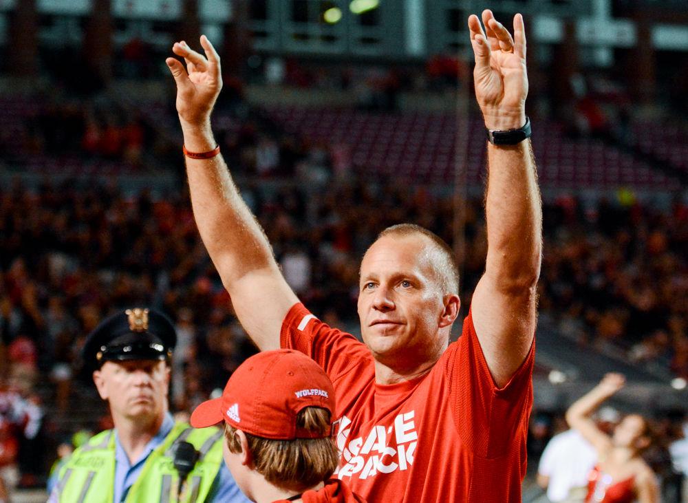 Coach Dave Doeren puts up his wolfies after the game against Louisville on Thursday, Oct 5, 2017. The Wolfpack won the game 39-25 at home in Carter Finley Stadium, after a 367 yard passing day for redshirt junior quarterback Ryan Finley.