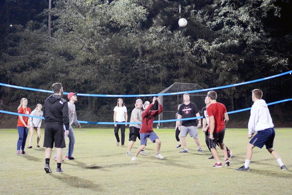 Shane Hooley, a second-year studying computer engineering, reaches for the volleyball during volleyball game at Campout on Miller Field on Friday. Campout included many activities for participants including volleyball, cornhole, popcorn, hot chocolate and snow cones.