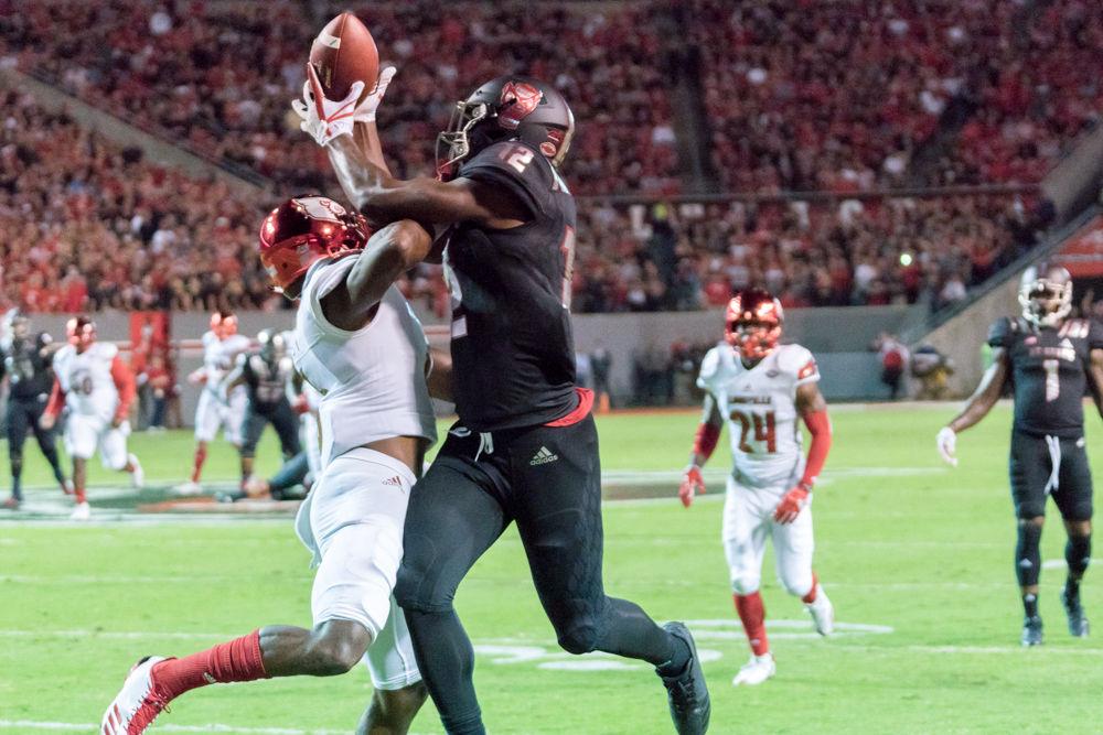 Redshirt junior wide reciever Stephen Louis catches a ball over a Louisville defender in the 39-25 win over Louisville in Carter-Finley Stadium on Thursday, October 5.