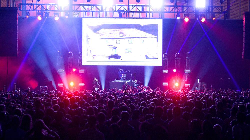 Fans on the floor swamp the stage as 2 Chainz preforms. Security guards had to hold down the barricades as the mass of people threatened to topple them over. The NC State Homecoming Concert is organized by UAB as a part of Red and White week at NC State. The concert took place at Reynolds Coliseum on Friday, Oct. 27.