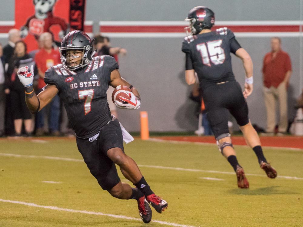 Junior running back Nyheim Hines carries the ball up field in the 39-25 win over Louisville in Carter-Finley Stadium on Thursday, October 5.
