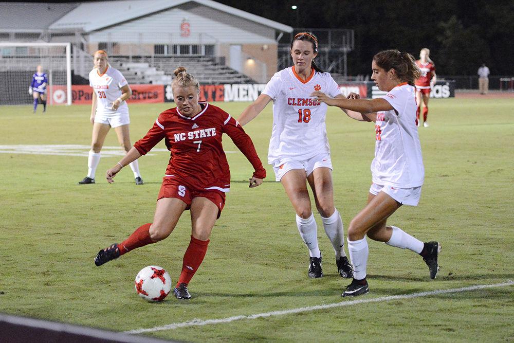 Sophmore midfielder Ricci Walkling fights through two Clemson Tigers to bring the ball upfield. The Wolfpack would go on to win the game 1-0 in Dail Soccer Stadium on Thursday.