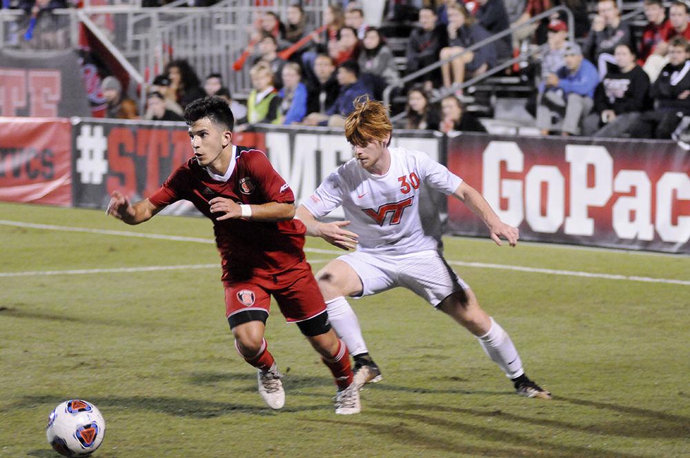 Freshman forward David Loera dives for the ball while fending off an opponent from Virginia Tech at the N.C. State V. Virginia Tech ACC men's soccer championship quarter-final on Wednesday, Nov. 1. The Wolfpack lost to Virginia Tech 1-0 in a single round of overtime.