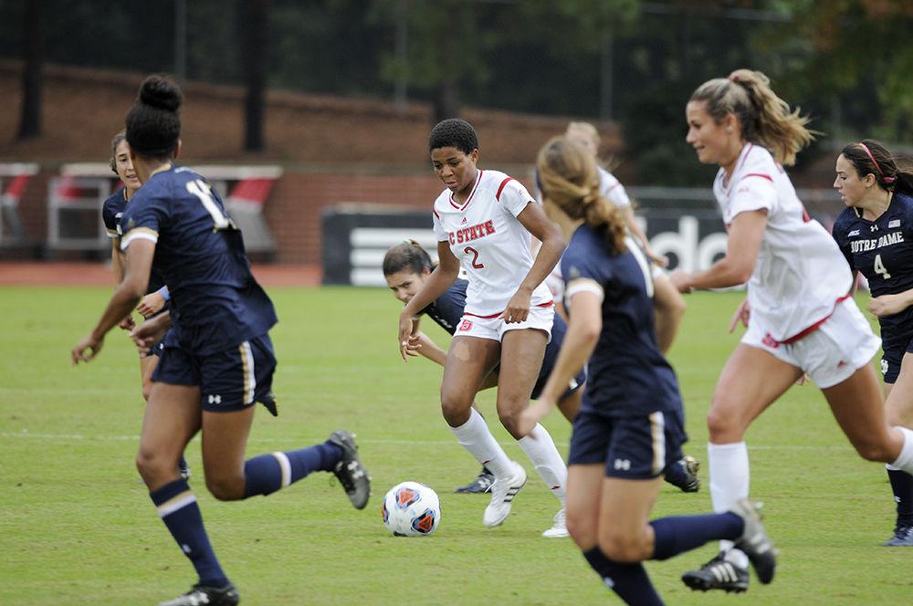 Sophomore midfielder Tziarra King fights through a swarm of opponents from Notre Dame at the NC State vs. Notre Dame women's soccer ACC quarterfinal in Dail Soccer Field on Sunday. NC State defeated the visitors from Notre Dame with a final score of 4-1.