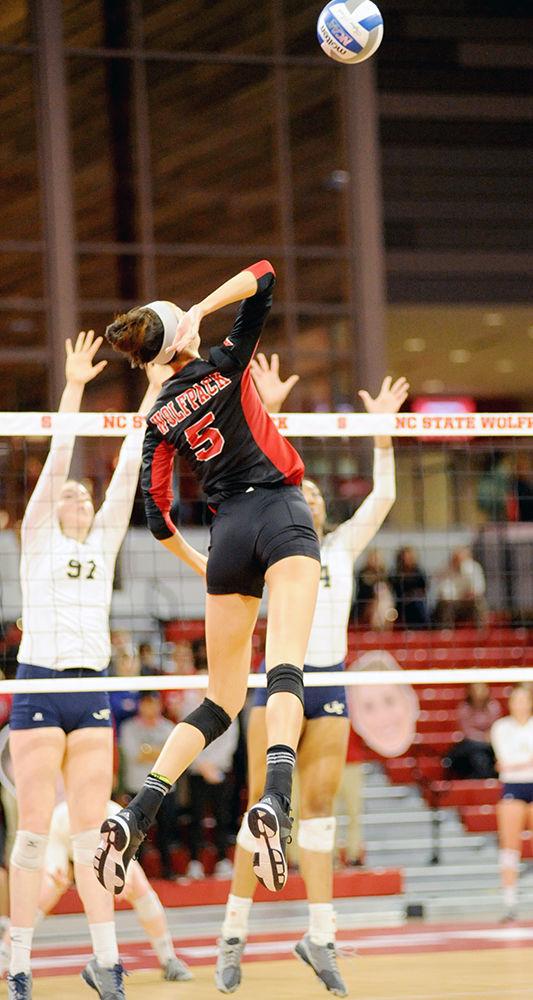 Graduate student Bree Bailey spikes the ball against Georgia Tech on Saturday at Reynolds Coliseum. The NC State volleyball team went on to win over Georgia Tech 3-0.