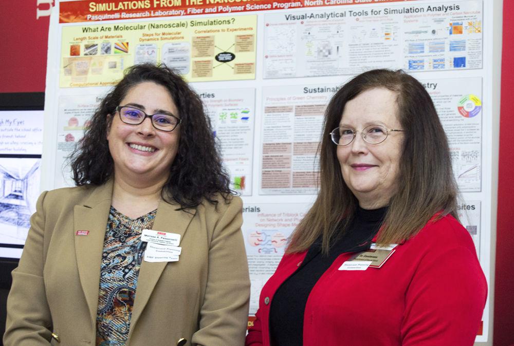 Professors Melissa Pasquinelli and Willa Casstevens stand together for a photo at the Showcase of NC State Women Faculty's Research, Creativity and Scholarship in the College of Textiles on Wednesday. The event included poster and video presentations, a formal program and a networking reception.