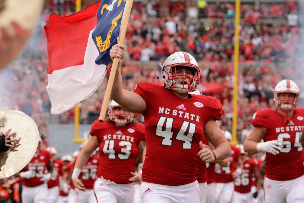 Redshirt graduate transfer defensive end Bryan Smith helps lead the Wolfpack onto the field before kickoff. The Wolfpack ened up falling to Clemson in a nail-biter 38-31 on Saturday, November 4, 2017 at Carter-Finley Stadium.