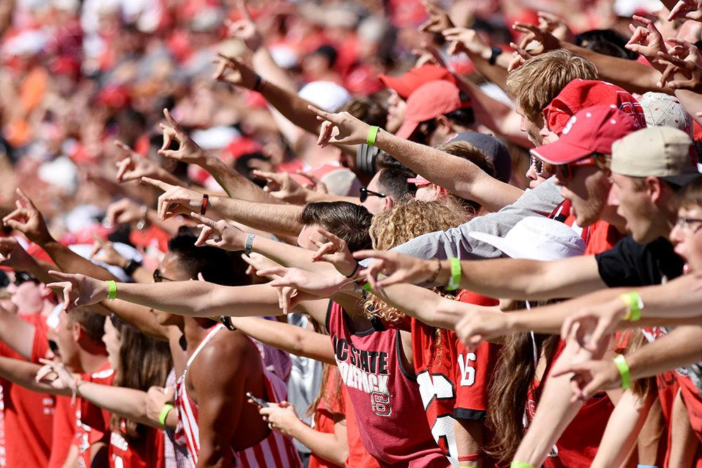 Wolfpack fans throw up the "wolfie", the signature sign of the N.C. State wolfpack at the N.C. State V. Syracuse game on Saturday. N.C. State prevailed over Syracuse in a 33-25 win for the Wolfpack.