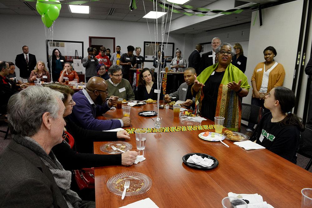 Toni 'Mama' Thorpe shares her experience with the Nubian Message while standing up in front of a table at the 25th anniversary celebration at the African American Cultural Center Thursday, Nov. 30.