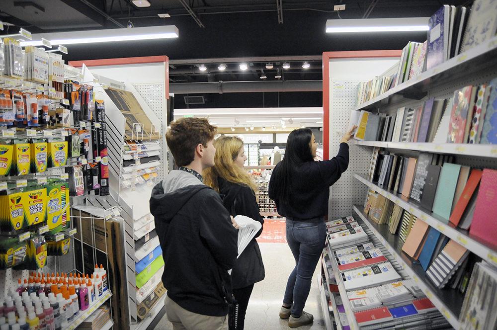 Audrey Roh, a third-year studying management, inspects a notebook while shopping with friends Gaven Kerr (closest) a second-year student studying computer science and Halle Michalak (middle), a second-year studying business administration, at the new Target on Hillsborough Street on Wednesday. The new Target, opened Tuesday in the former location of The Alley, a bowling alley that used to reside across from NC State University.