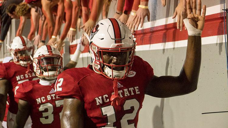 Redshirt junior wide reciever Stephen Louis hangs his head in defeat while passing the student section and exiting the field. Despite the 38-31 loss, the Wolfpack offense had a day with 338 yards in the air and 153 yards on the ground on Saturday, November 4, 2017 at Carter-Finley Stadium.