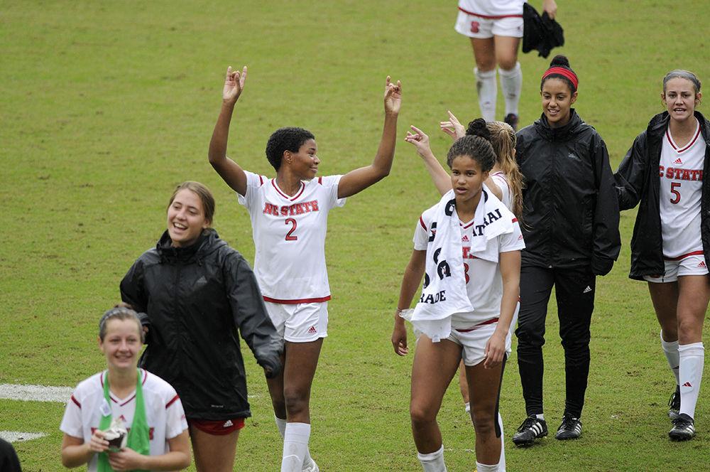 Sophomore midfielder Tziarra King throws up the "wolfie" as she and her teammates walk off field in Dail Soccer Stadium at the N.C. State vs. Notre Dame women's soccer ACC quarter final on Sunday Oct.29. N.C. State defeated the visitors from Notre Dame with a final score of 4-1.