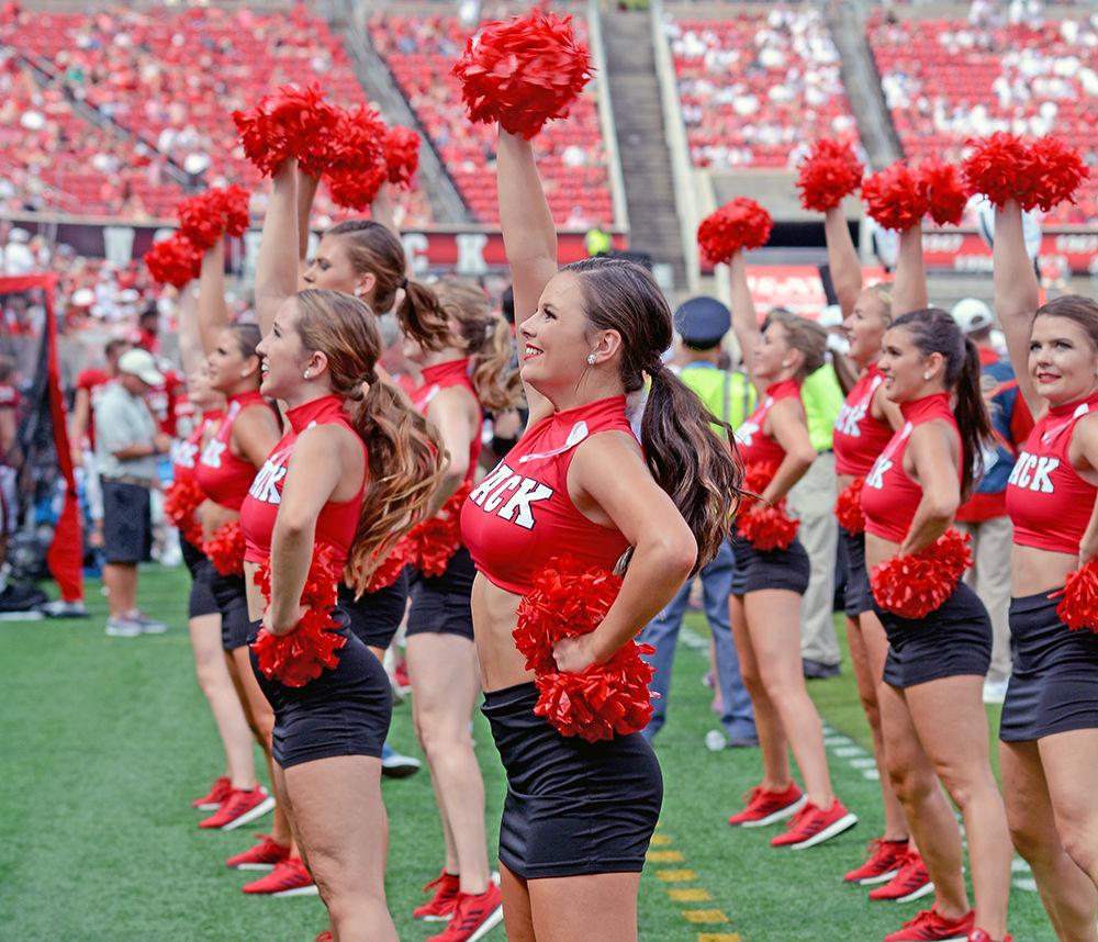 Members of the NC State Dance Team dance to the marching band's rendition of the song "Hey Baby" at Carter-Finley Stadium on Sept. 16. The Saturday game against Furman University resulted in a 49-16 win for NC State.&#160;