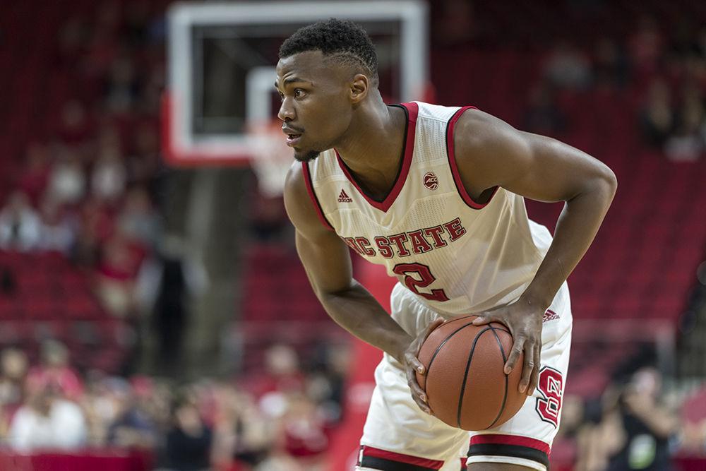 Redshirt junior Torin Dorn scans the court for an open player during the third home game of the season against Bryant. Dorn played for 27 minutes with a 79% field goal average. The Wolfpack beat Bryant 95-72 in regulation at PNC Arena on Tuesday, November 14.