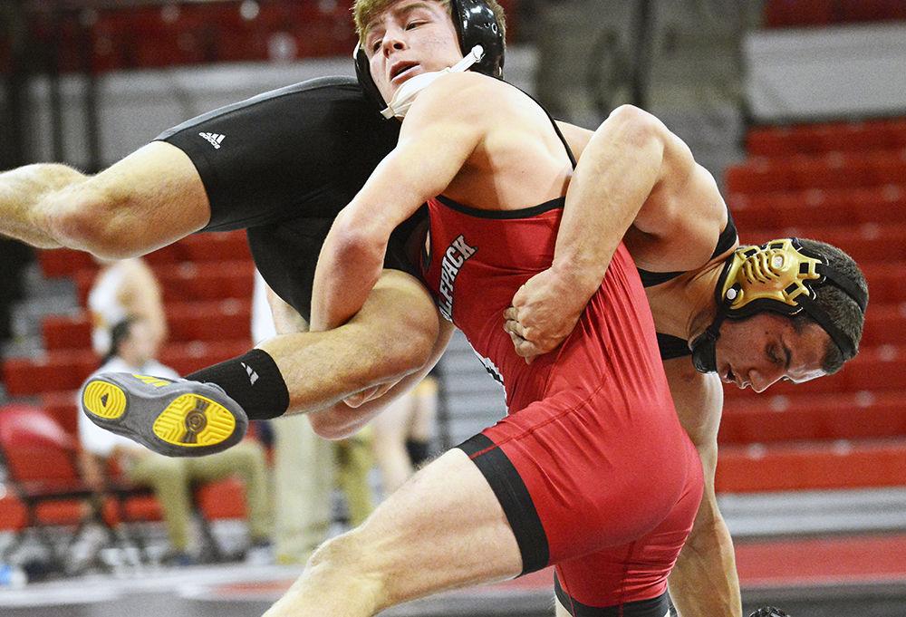 Redshirt Daniel Bullard flips UNC Pembroke opponent during the wrestling match in Reynolds Coliseum on Saturday. The final score for NC State-Pembroke was 48-0, contributing to an overall victory over UNC Pembroke, Utah Valley and Reinhardt.