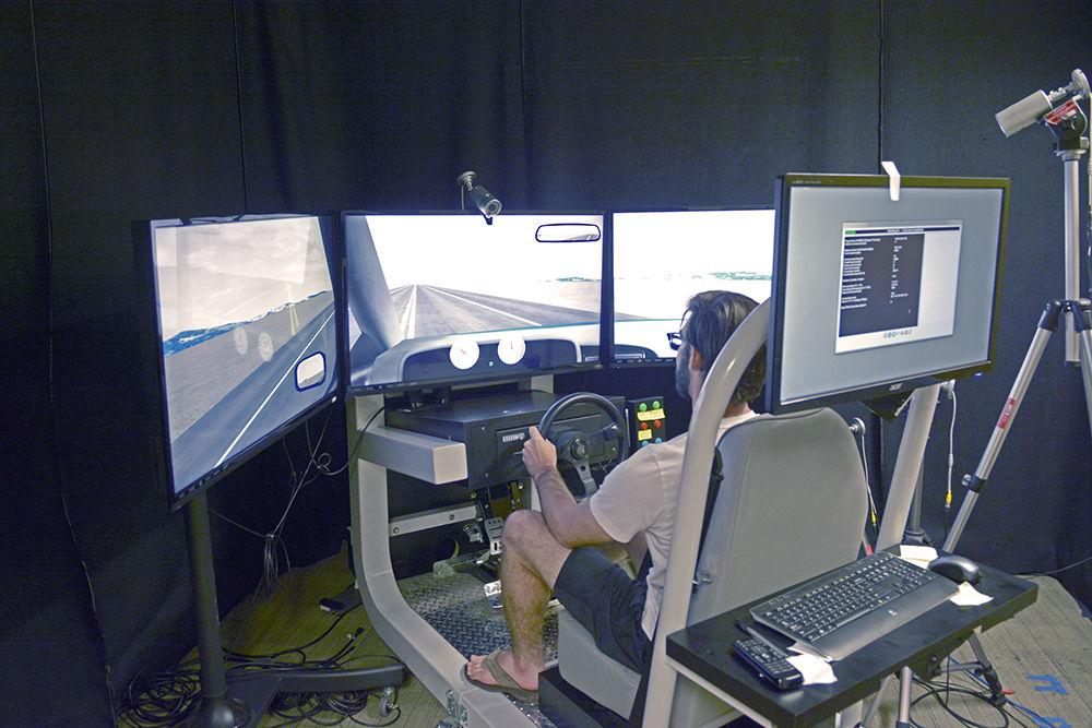 Micheal Geden, a Ph.D. candidate at NC State and the lead author of a paper on the work, sits in the driver's seat testing out one of the many programs available on the driving simulator. This picture was taken on October 26th in Poe Hall.