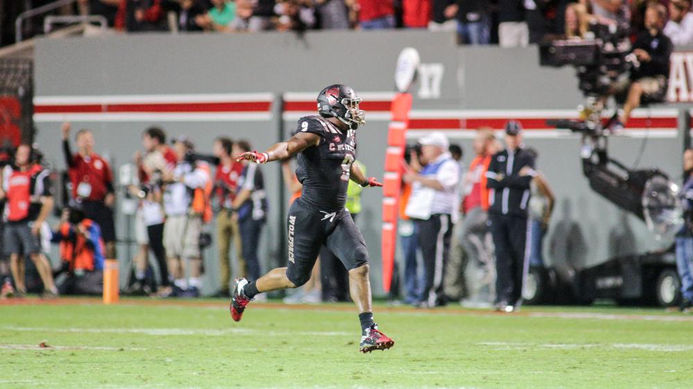 Senior defensive end Bradley Chubb pulls his best "JaySam" impression and flies off the field after blocking a PAT late in the fourth. Chubb had one sack, one block and two quarterback hurries during the 39-25 win over Louisville in Carter-Finley Stadium on Thursday, Oct. 5.