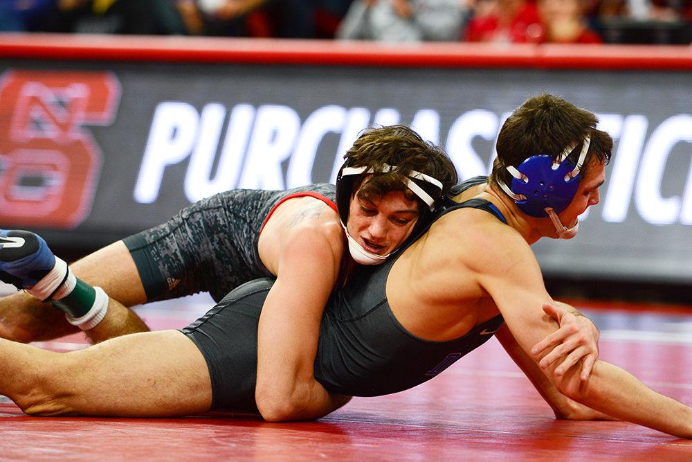 Junior Kevin Jack lunges around a Duke wrestler for a takedown. The NC State wrestling team beat Duke 34-6 in the ACC opener at Reynolds Coliseum on Jan. 11.