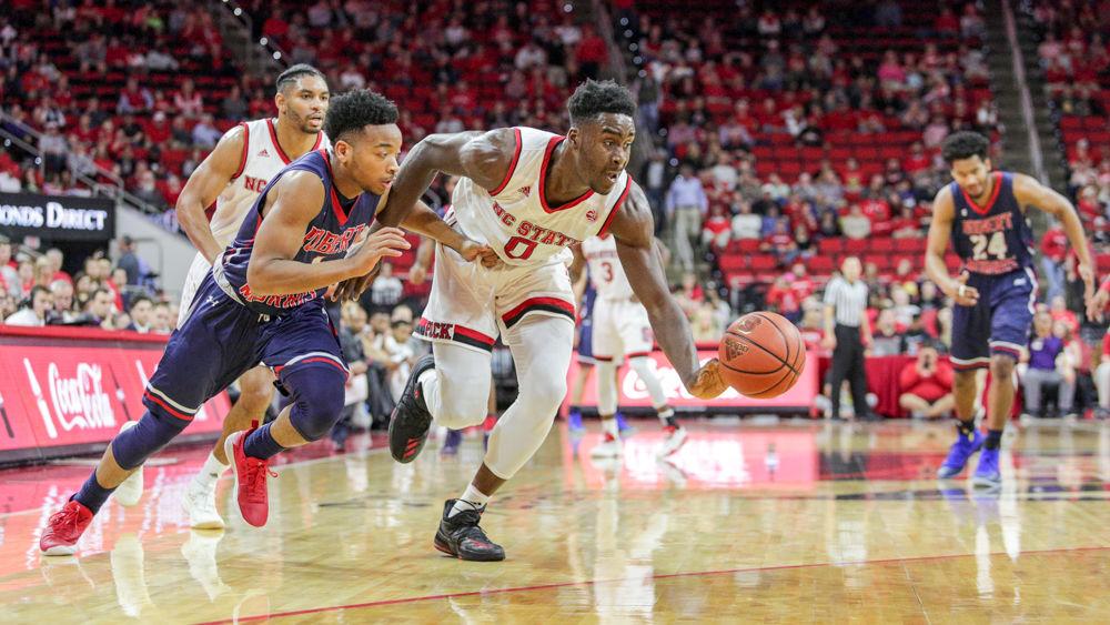 Senior forward Abdul-Malik Abu steals the ball and heads toward the basket. Abu had his best game of the season with 15 points, seven boards, two blocks and a steal. The Wolfpack struggled early trailing all but 57 seconds of the first half, but came out a different team in the second half to win 81-69 over Robert Morris in PNC Arena on Tuesday, Dec. 19.