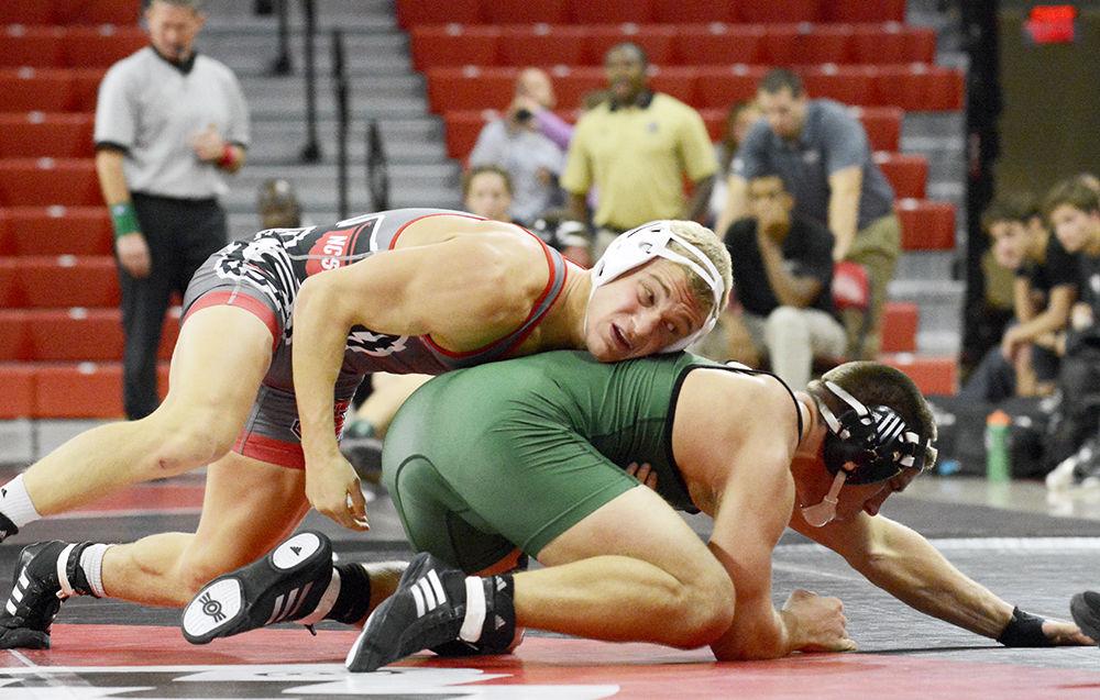 Redshirt Hayden Hidlay takes down Utah Valley opponent during the wrestling match in Reynolds Coliseum on Saturday, Nov 18. At 157 pounds, Hidlay took down the other team's wrestler to continue the team's winning streak. Wolfpack beat Utah 34-6, along with victories over UNC Pembroke and Reinhardt.
