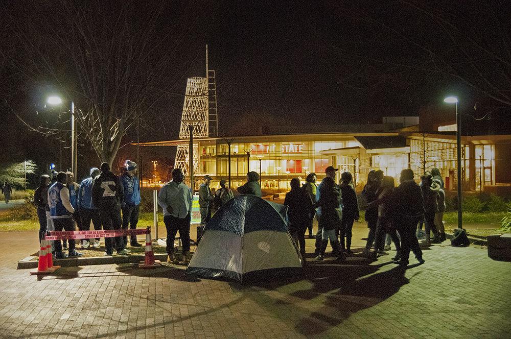 The Xi Zeta chapter of Phi Beta Sigma Fraternity Inc. gather around shelters set up in Wolf Plaza at their event "Sleep Out for the Homeless" on Tuesday, Jan. 9, 2017. The event seeks to raise awareness about the epidemic and causes of homelessness as well as serve as a receptacle for donations to a local homeless shelter. Music, dancing, and hot chocolate were presented to those who chose to attend and give back to the community by donating clothes, coats, or blankets.