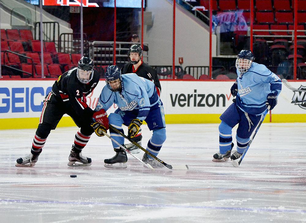 Sam Banasiewicz, a fourth-year studying public relations, fights for the puck during the club hockey game against UNC-Chapel Hill on Monday, Jan. 29 in PNC Arena. The Wolfpack beat the Tar Heels 6-5.