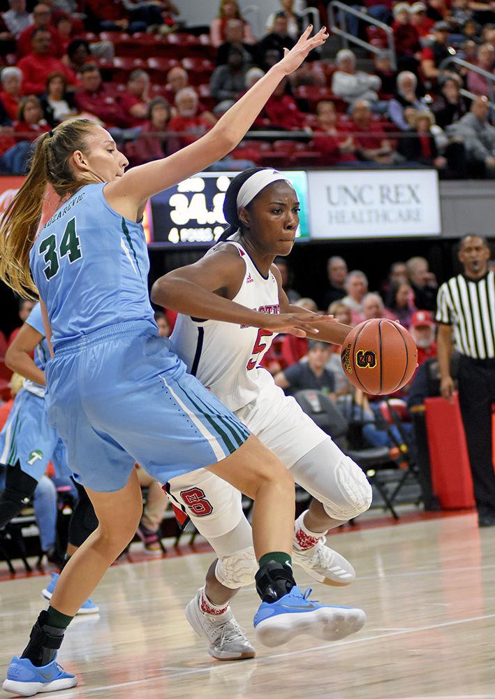 Senior forward Chelsea Nelson drives past a Tulane defender during NC State's 79-55 win on Dec. 3 at Reynolds Coliseum. Nelson contributed 16 points, three assists, and eight rebounds as the Wolfpack went into winter break at 7-2.