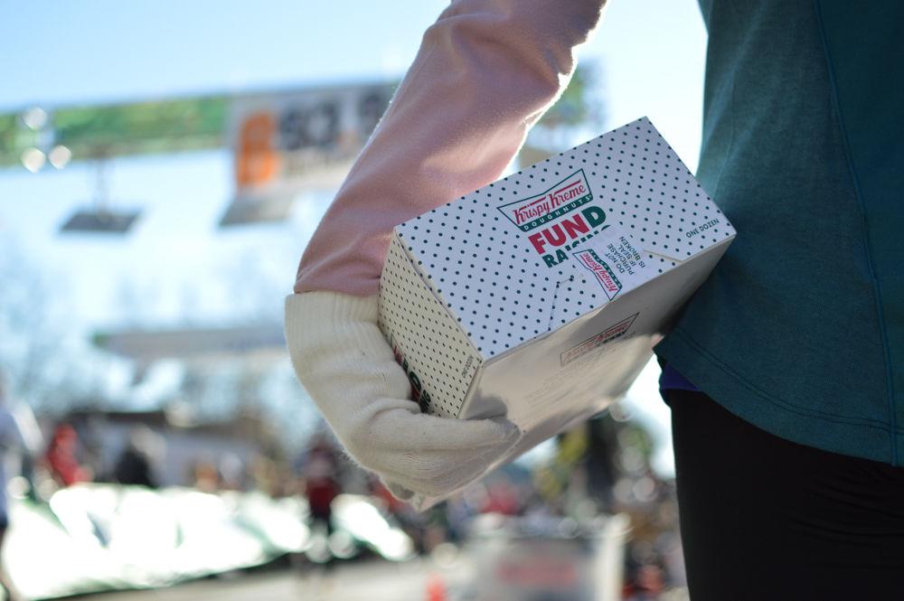 A young competitor holds her doughnut box after finishing the Krispy Kreme Challenge on Feb. 4, 2017. This was the 13th annual Krispy Kreme Challenge, with all proceeds going to support the UNC Children's Hospital, a hospital designed to cater to the needs of sick or injured children and their families. Competitors can choose to race as a challenger, a casual runner, or a no doughnut runner.