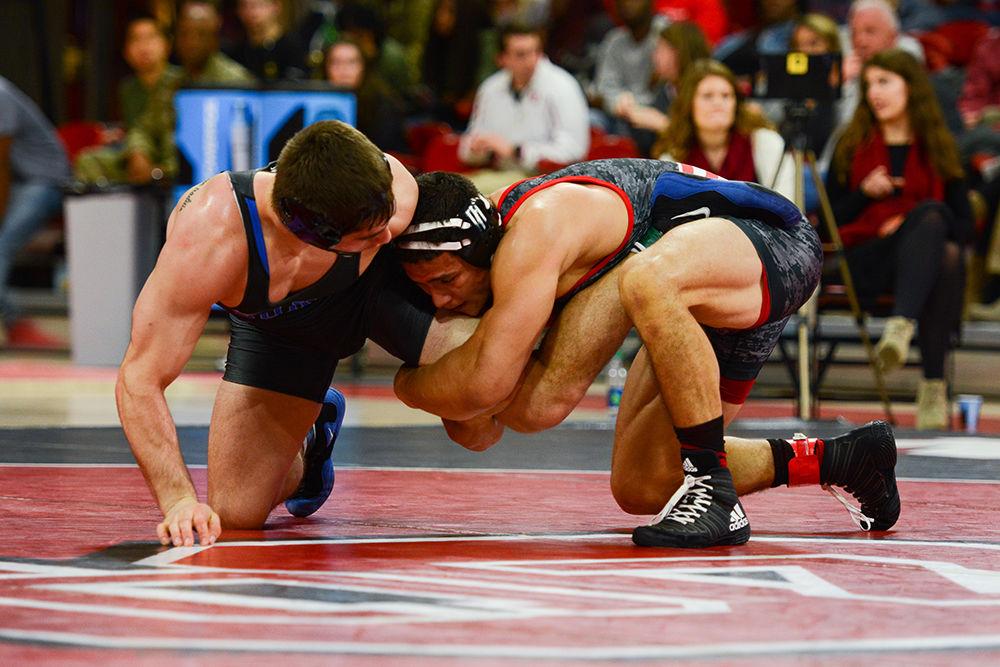 Redshirt junior Michael Macchiavello holds the leg of a Duke wrestler. The NC State wrestling team beat Duke 34-6 in the ACC opener at Reynolds Coliseum on Jan. 11.