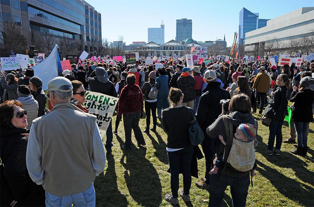Protesters stand among one another on Halifax Mall in downtown Raleigh in the Women's Rally on Raleigh on Saturday. The Women's Rally on Raleigh is a rally supporting women's rights consisting of live protest music, several speakers, and like-minded people coming together to protest a multitude of moral issues.