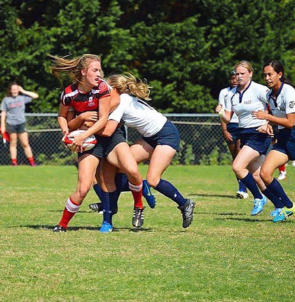 Outside center Guste Rubikaite gets tackled during a Women&#8217;s Rugby Club match. Rubikaite is one of the captains of the Women&#8217;s Rugby Club.