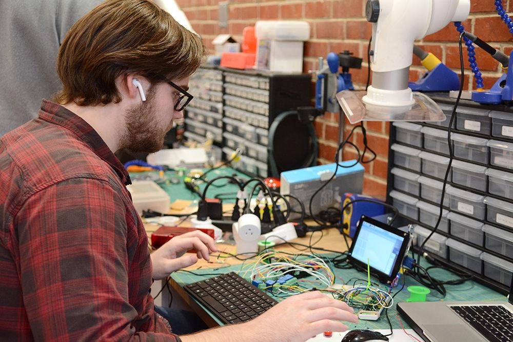 Ryan Kelley, a fourth-year student studying mechanical engineering, works on an "Internet of things upfit" meant to improve the efficiency of working parts in factories during Make-a-thon in the D. H. Hill Makerspace on Saturday, Jan. 27, 2018. Make-a-thon is an annual three-day challenge at NC State for which student teams work together to research design, prototype, and build new sustainability solutions.