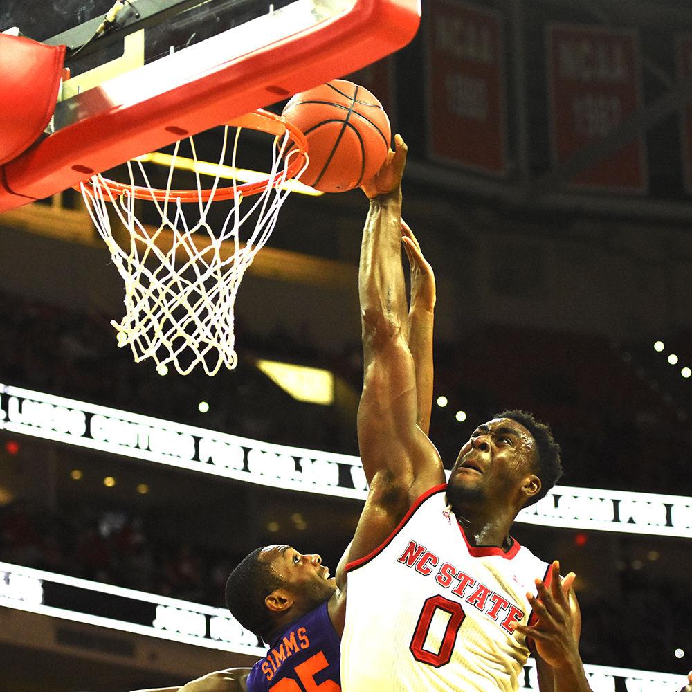 Senior forward Abdul-Malik Abu dunks over Clemson's Aamir Simms early in the first half. The Wolfpack held off the Clemson Tigers for a 78-77 nail-biter on Thursday, Jan. 12 in PNC Arena.