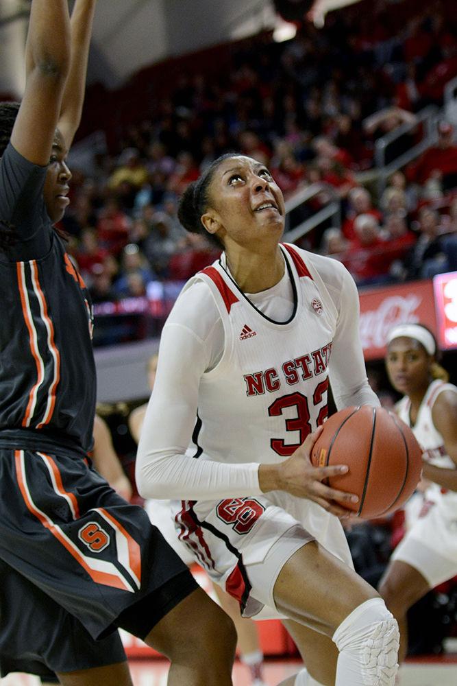 Senior center Akela Maize drives to the basket in Reynolds Coliseum on Sunday. Maize scored 11 points in the 60-56 win against Syracuse, head coach Wes Moore's 100th win with the Wolfpack.