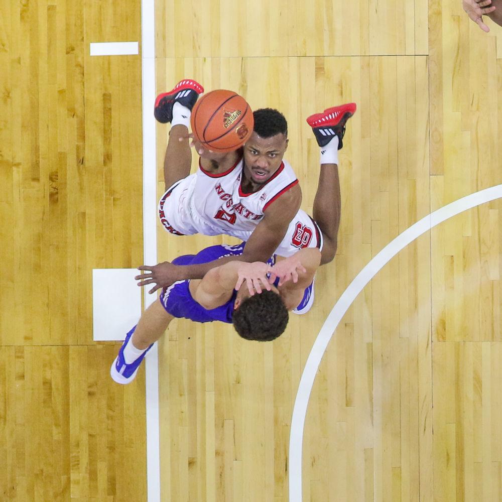 Redshirt junior guard Torin Dorn is contested as he goes up for a shot. Dorn nearly posted a double-double with 18 points and nine boards during the 86-68 win over Presbyterian College on Thursday, Nov. 16 in PNC Arena.