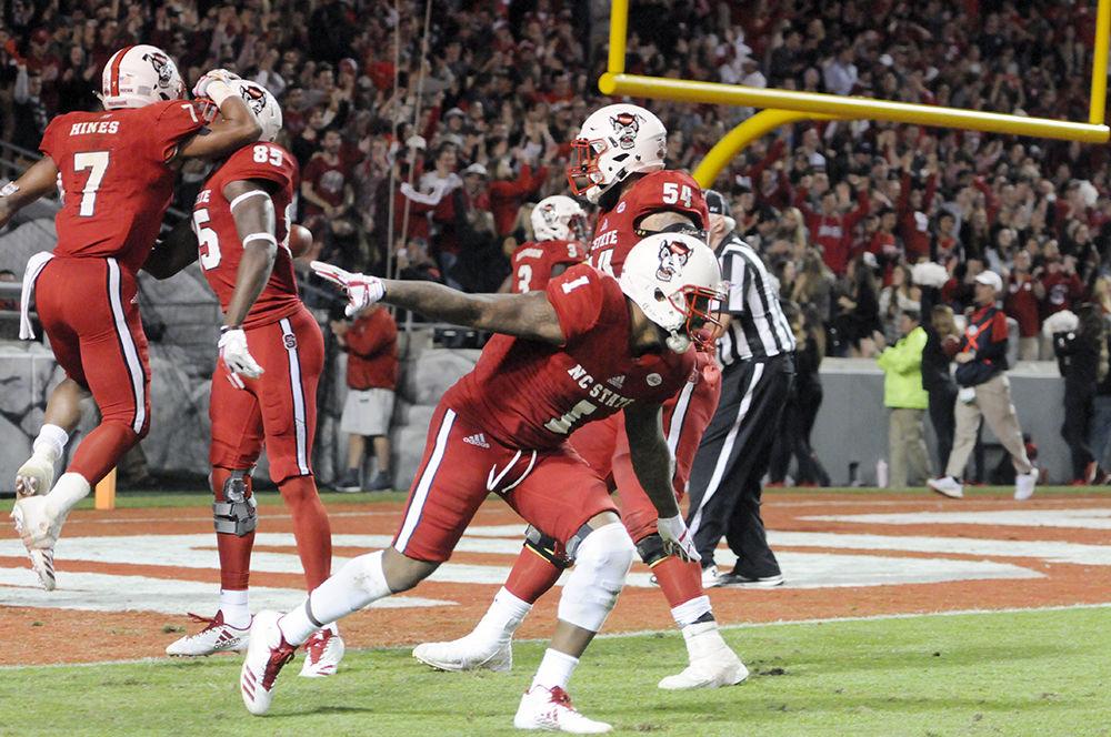 Senior halfback Jaylen Samuels celebrates after scoring a touchdown at the NC State vs. UNC-Chapel Hill football game in Carter-Finley Stadium on Saturday. The Wolfpack won 21-33 claiming its eighth win of the season.