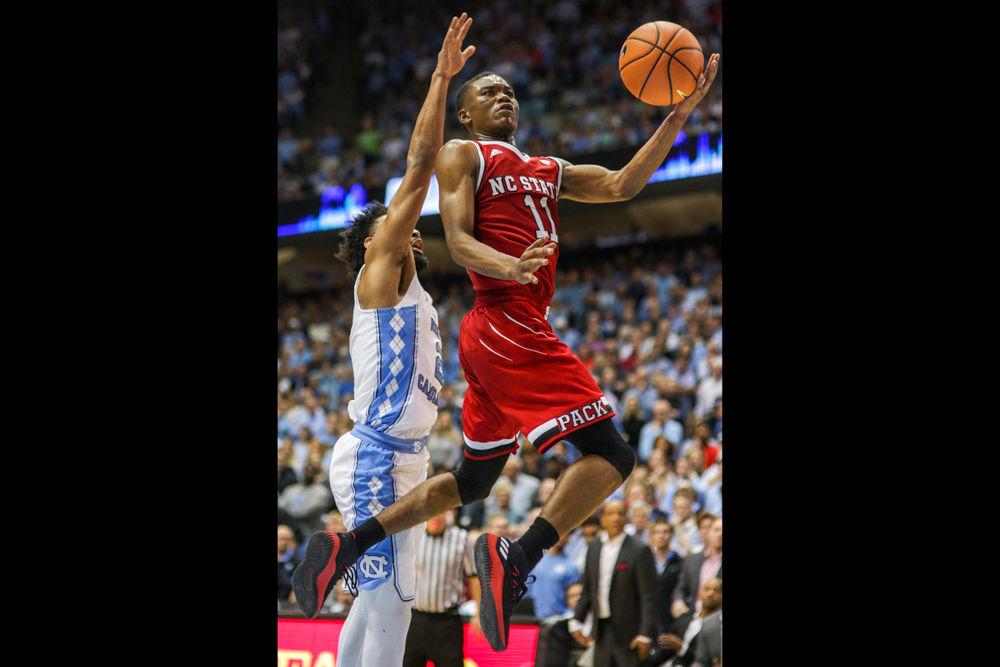 Sophomore guard Markell Johnson drives inside and goes up for a quick basket. Johnson was a huge force handling the ball, and recorded a double-double with 20 points and 11 assists. The Wolfpack came away with the win in a 95-91 overtime thriller on Saturday, Jan. 27 in the Smith Center.