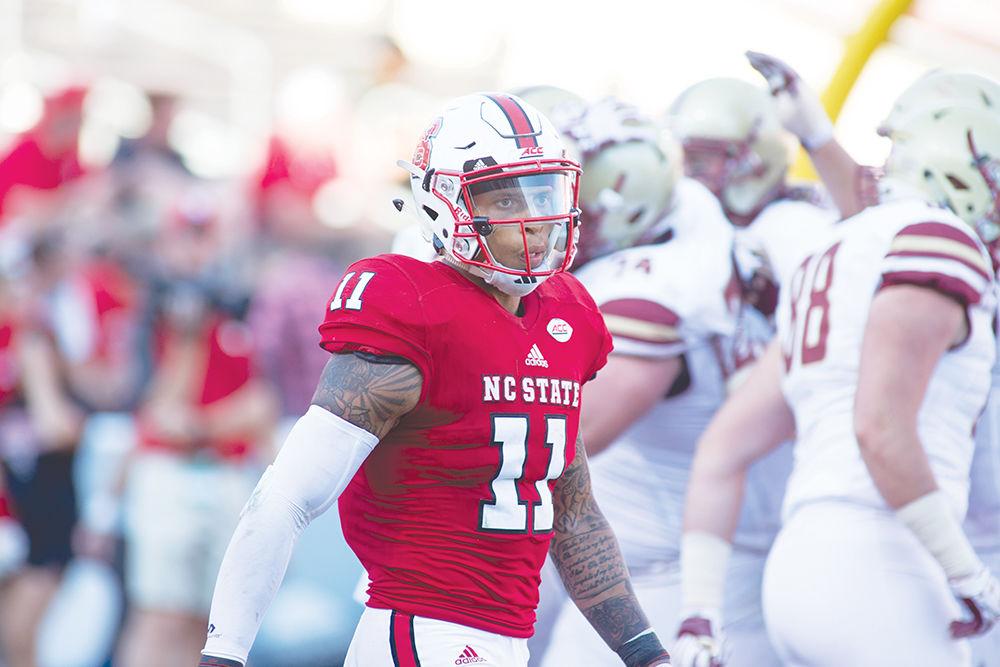 Redshirt safety Josh Jones walks off the field as Boston College celebrates their touchdown during the 21-14 homecoming loss to Boston College on Oct. 29, 2016 in Carter Finley Stadium.