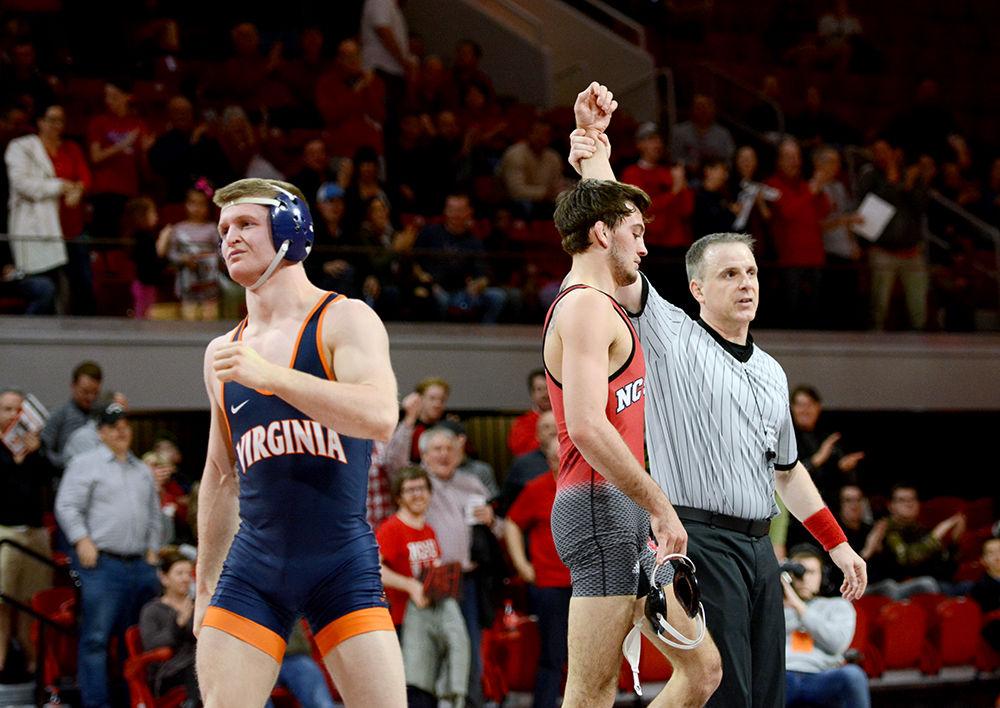 Senior Kevin Jack defeats Virginia opponent during the wrestling match in Reynolds Coliseum on Jan. 26. Jack's win gave the Wolfpack the final points needed to defeat Virginia. The overall score was 32-7, adding to Wolfpack's 12-1 record for the season.