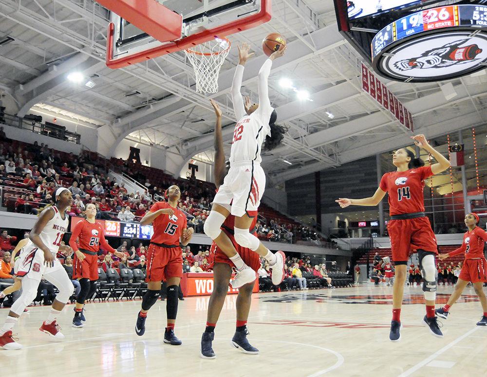 Senior center Akela Maize jumps to dunk the ball while playing against the University of Southern Alabama in the women's basketball game in Reynolds Coliseum on Nov. 17. The Wolfpack beat the Jaguars, 71-50, in a thus far undefeated regular season.
