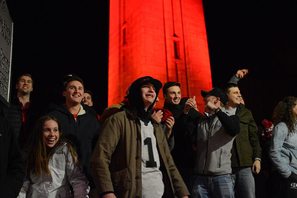 Students and others gather at the Memorial Belltower on Saturday Jan. 6 to celebrate the NC State Men's Basketball win over Duke University. Wolfpack secured the 96-85 win at PNC Arena.