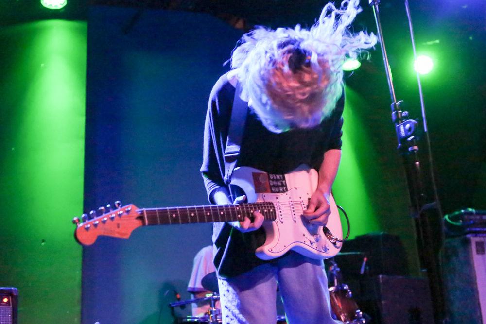 Trav, of Astro Cowboy, head bangs during a song at Double Barrel Benefit 14 on Feb. 25, at Kings in downtown Raleigh.