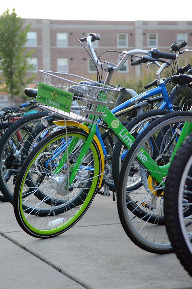 Outside of Owen Residence Hall on Sept. 3, a LimeBike is seen parked among other bicycles. By using their NC State email address, NC State students and employees are able to ride LimeBikes at a rate of $0.50 per 30-minute ride.&#160;