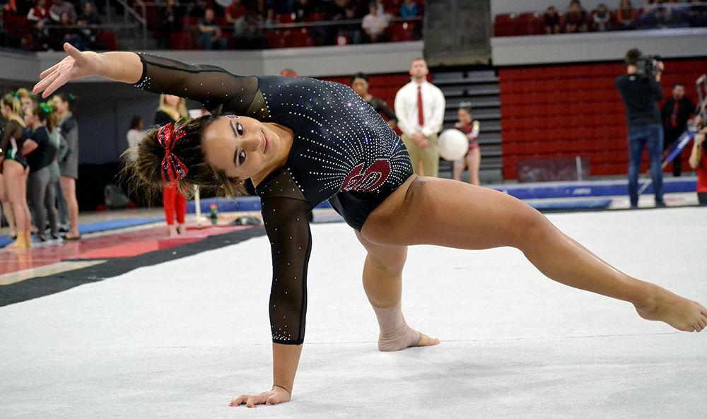 Sophomore Drew Grantham performs on the floor during a tri-meet against William &amp; Mary and Ball State on Jan. 20 in Reynolds Coliseum. Grantham finished first with 9.875 points for this event. The Wolfpack beat both other schools, with a final score of 196.350, to Ball State's 14.750 and William &amp; Mary's 193.300.