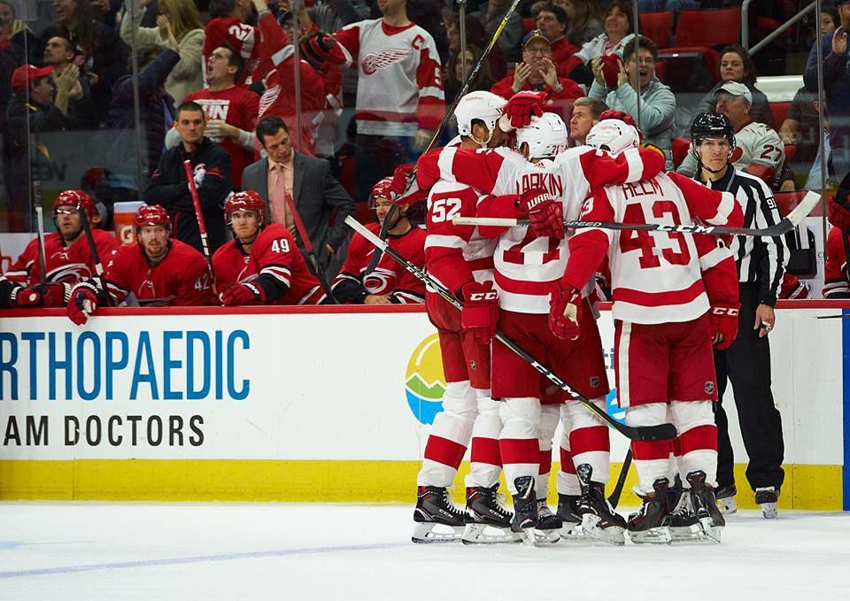 The Detroit Red Wings celebrate Darren Helm's goal late in the third period in front of the Hurricanes bench at PNC Arena on Friday, February 2, for a 4-1 Red Wings victory.